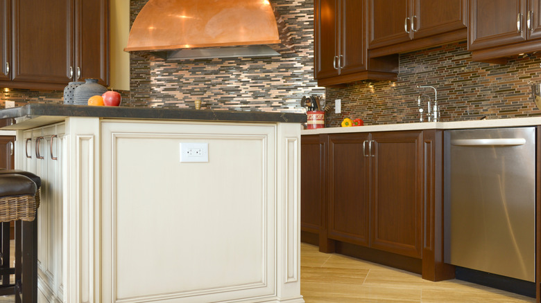 Kitchen island with a side-mounted outlet