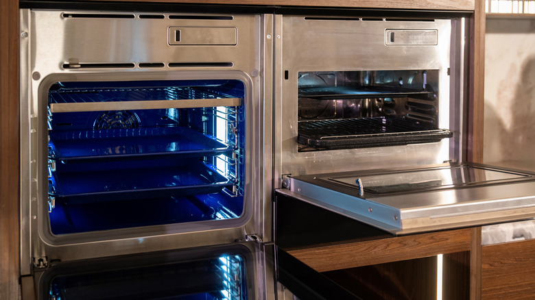 Two built-in stainless open ovens, blue and silver interior