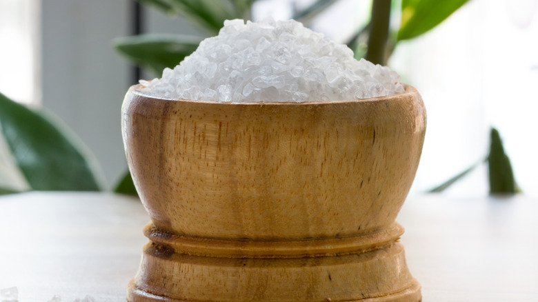 Bowl of salt sitting on white table