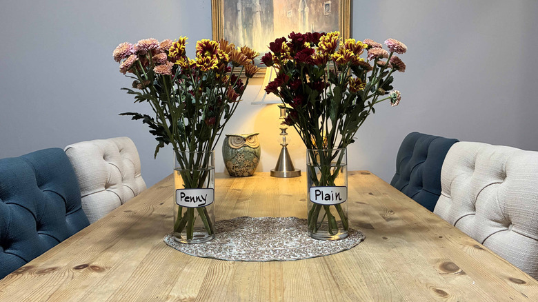 Two vases of fresh flowers on table for penny experiment