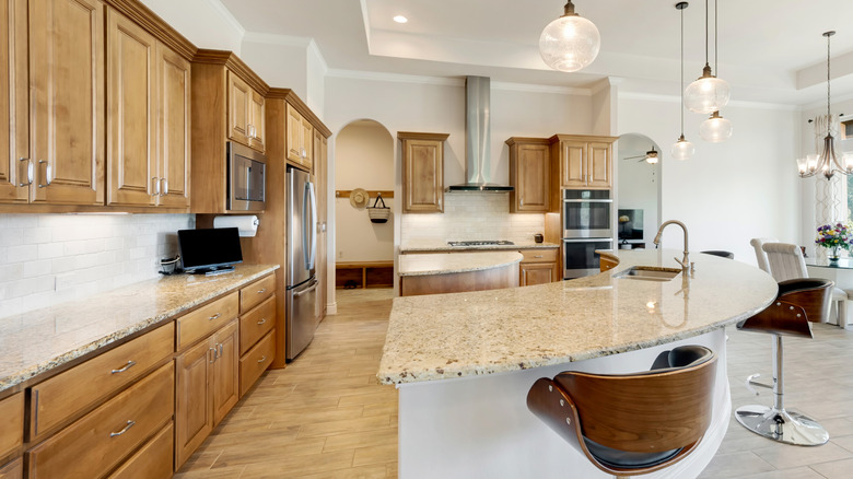 oak wood kitchen with an off-white tile backsplash