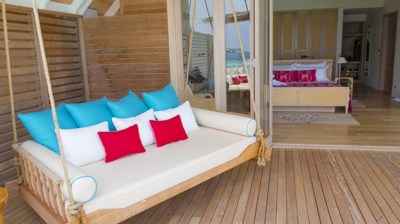 Swinging daybed on modern home's porch