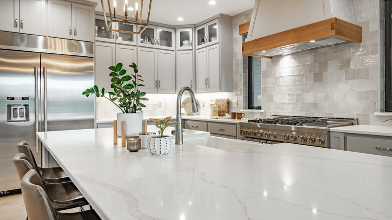A modern kitchen with white quartz countertops