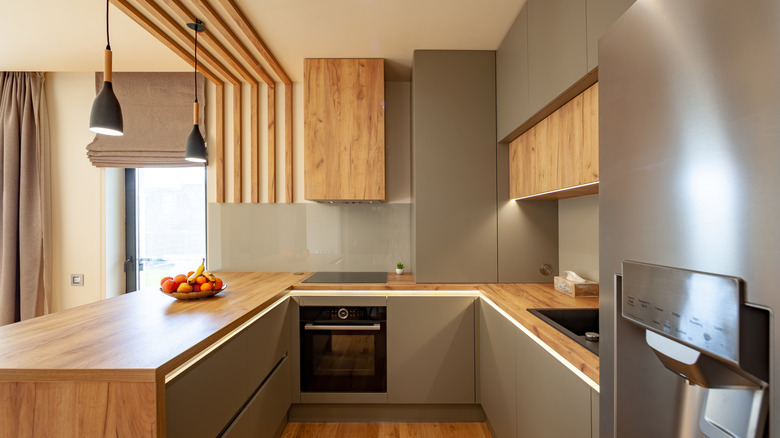 Modern small kitchen with wooden peninsula