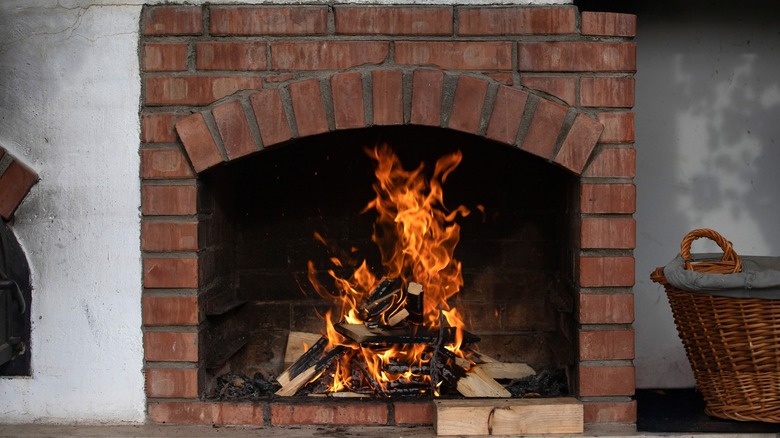 Roaring fire in a brick-lined fireplace