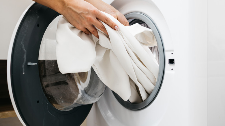 pulling clothes out of a clothes dryer