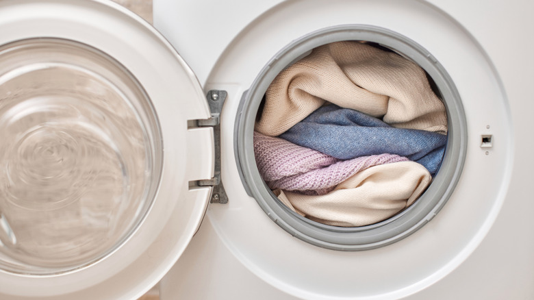 A dryer filled to the brim with knit items