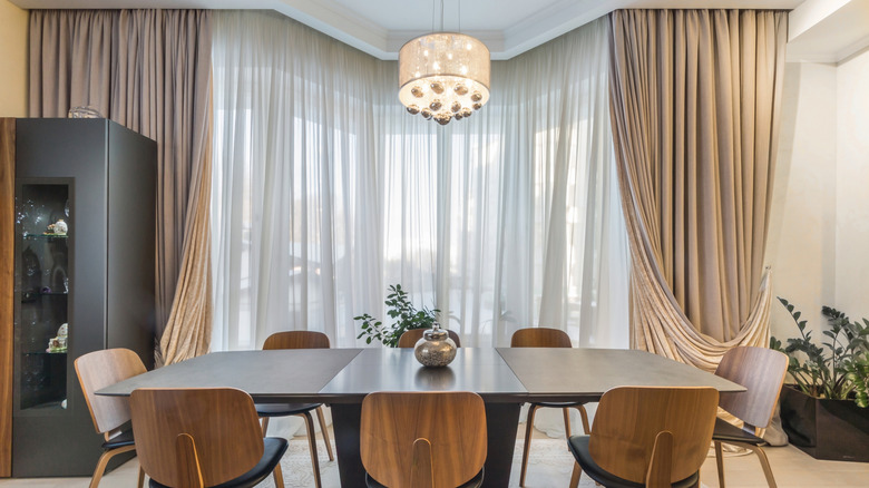 Dramatic drapes behind dining room table