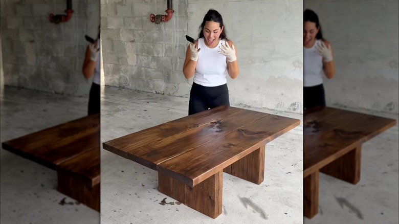 woman smiling at DIY wooden table