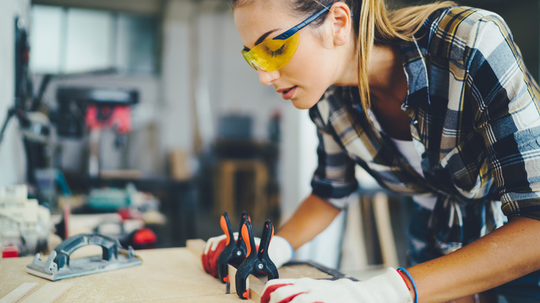 woman clamping wood boards