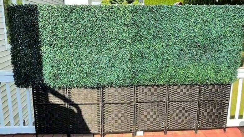 DIY privacy screen on deck made from room divider and greenery panels