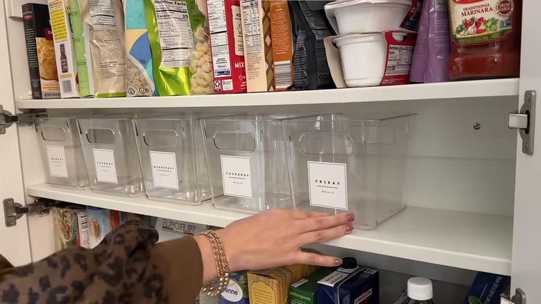 clear organizer bins lined up on a shelf