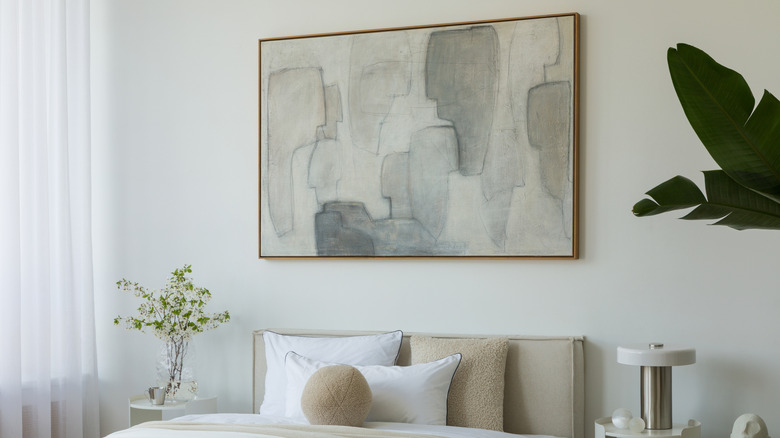 A large abstract painting in a bedroom