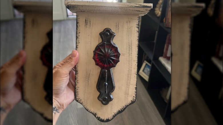 Creator holding up her door knob ready to start the project