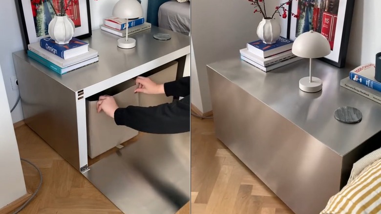 Aluminum plinth side table with books, lamp, and framed artwork on top