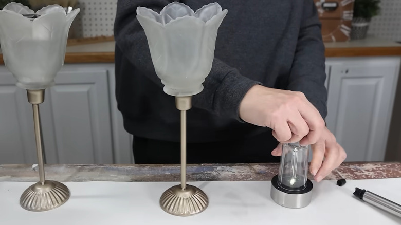 Creator assembling a lantern-style solar light display