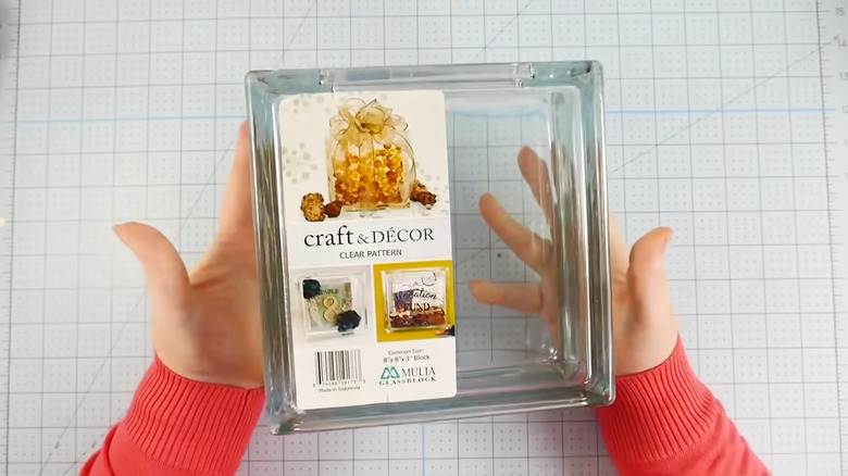 Crafter holding a glass block and getting ready to make a project