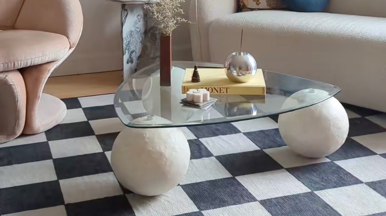 Decor on a glass-topped coffee table made from IKEA metal serving bowls