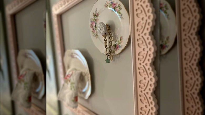 A bracelet looped around a vintage plate with a knob in its center