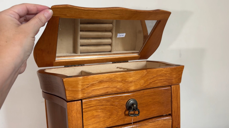 Woman opening a vintage wooden jewelry box