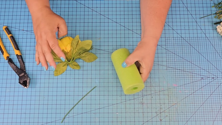 pool noodle and artificial flower on craft mat