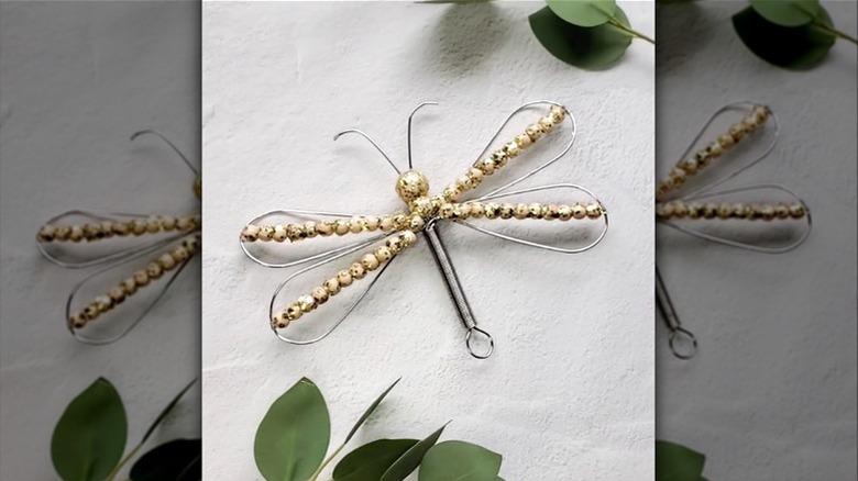 a DIY dragonfly made from an old whisk and beads