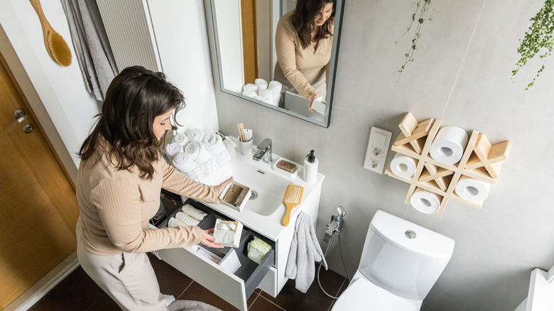 Woman in the process of organizing a bathroom