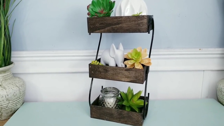 Three-tiered organizer made from Dollar Tree trays and hooks