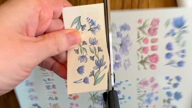 Hands cutting out temporary tattoos
