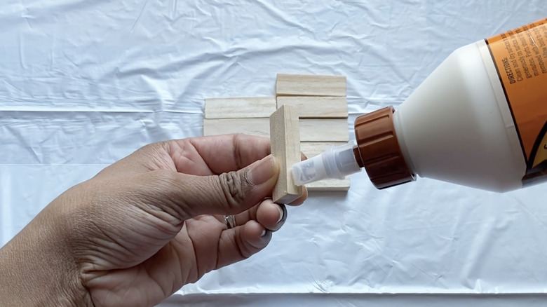 applying glue to wood block