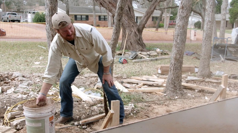 Chip Gaines working on concrete patio.