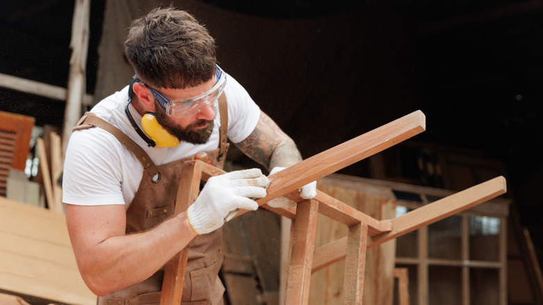 A man making furniture out of wood
