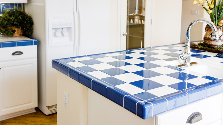 A bright blue and white tiled kitchen countertop