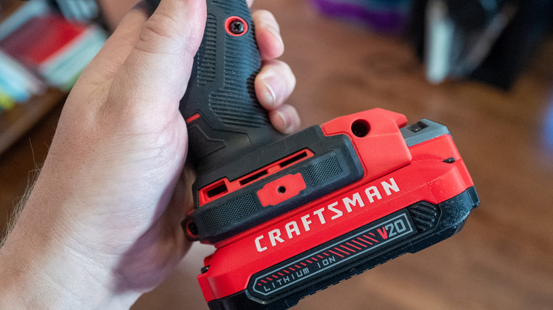 Closeup on hands holding a Craftsman power drill