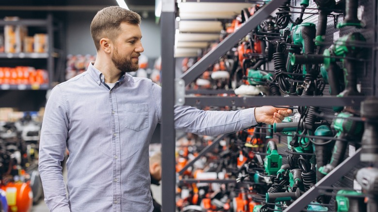 Man shopping for power tools in home improvement store