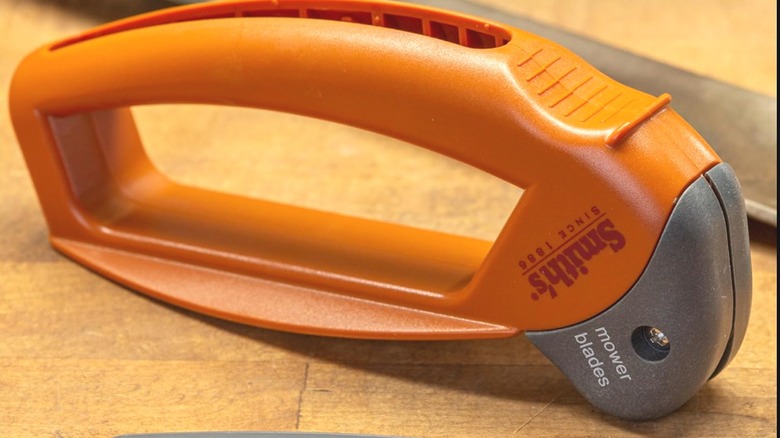 A manual lawn mower blade sharpener