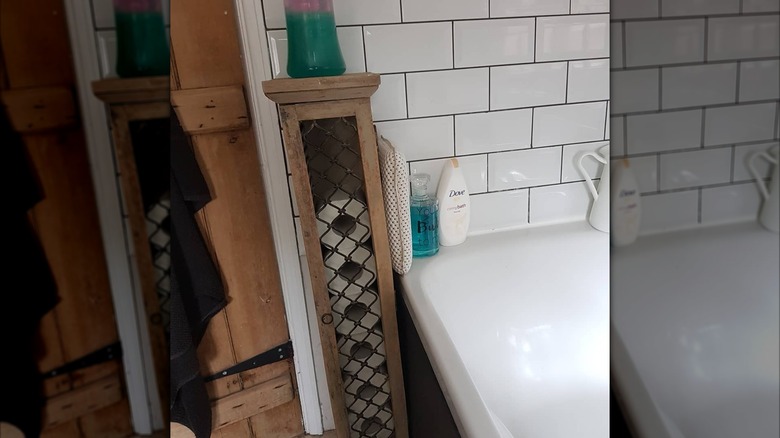 A wooden CD holder with rolls of toilet paper stacked inside