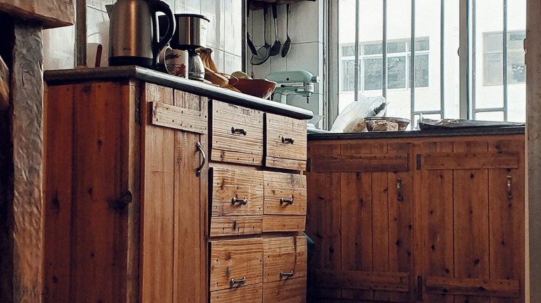 Antiqued brown pine cabinets in an upscale kitchen
