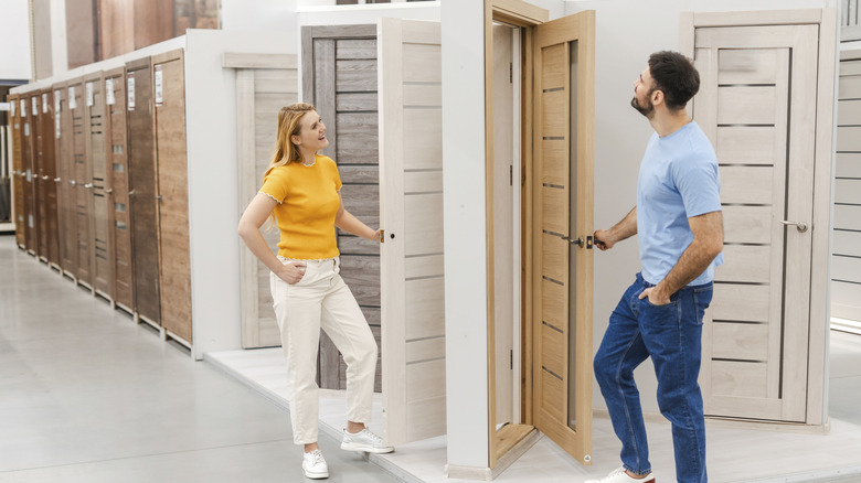 Two people shopping for doors in a showroom