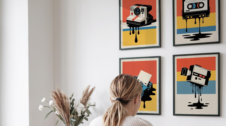 Framed prints depicting Polaroid camera, cassette tape, typewriter, and tape-based video recorder
