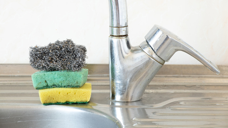 Kitchen sink and pile of sponges
