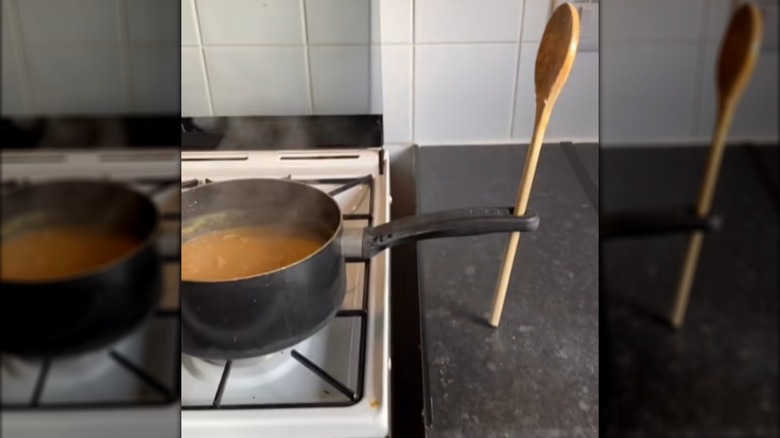 wooden spoon through hole on pot handle