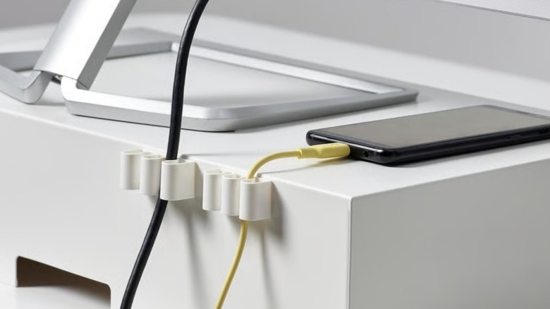 Cable clips holding wires on a desk